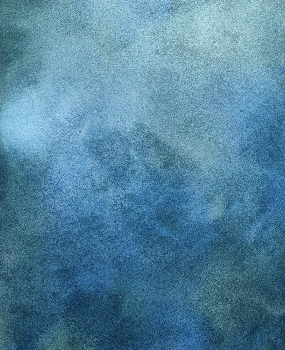 Abstract texture in shades of blue and soft grey, resembling clouds or fog.