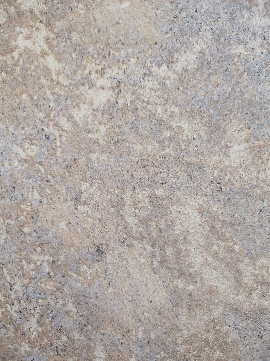 Textured surface in shades of beige and grey with subtle variations.